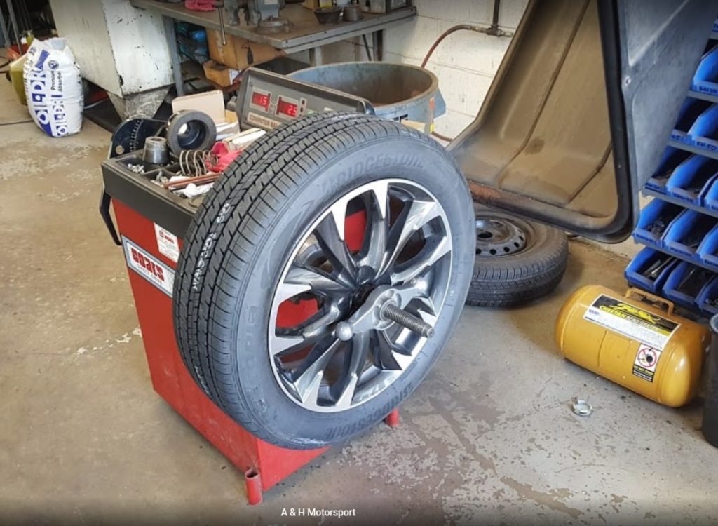Tire balancing machine with car wheel in auto repair service center in Warminster, PA